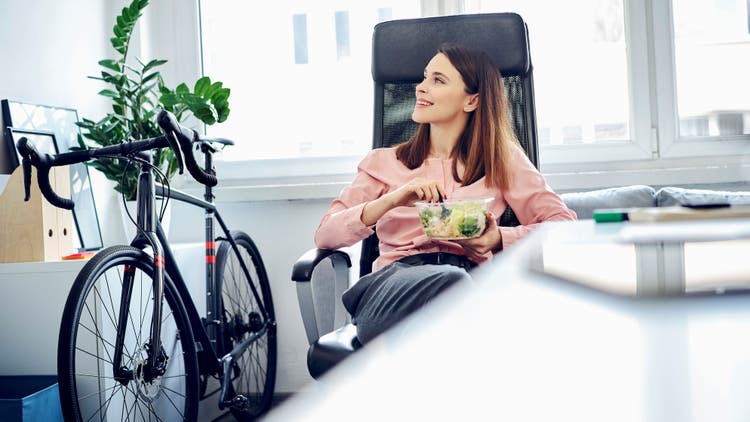 A woman sitting on a chair having food