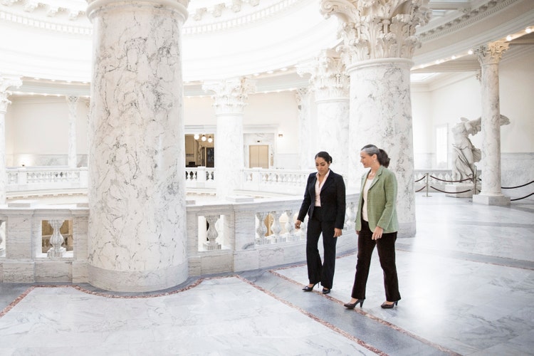 Two women walking through government building