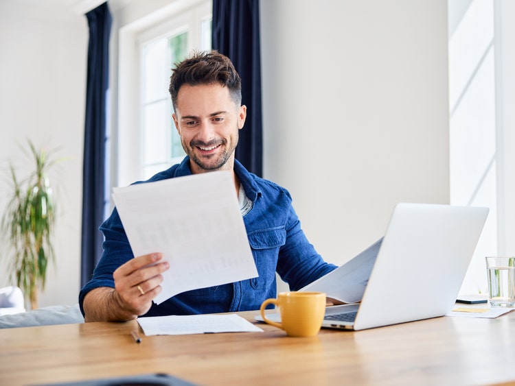 man looking at investment information on computer