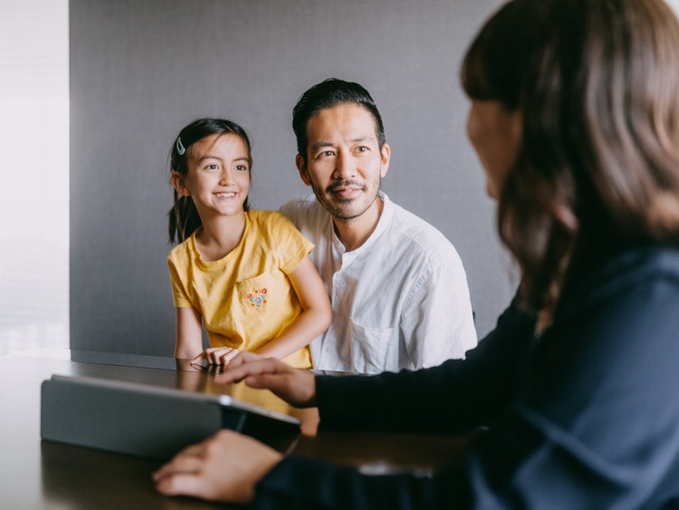 Father and daughter in a meeting with an advisor