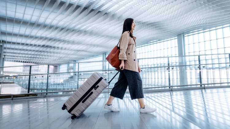 A woman carrying a trolley
