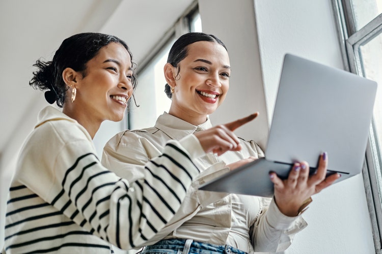 two women looking at computer